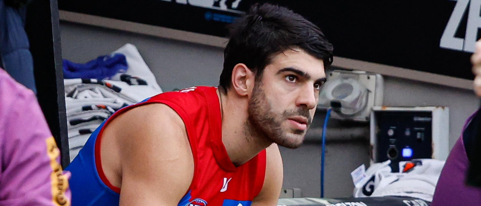 MELBOURNE, AUSTRALIA - JUNE 10: Christian Petracca of the Demons is seen on the bench after leaving the ground with a rib injury during the 2024 AFL Round 13 match between the Collingwood Magpies and the Melbourne Demons at The Melbourne Cricket Ground on June 10, 2024 in Melbourne, Australia. (Photo by Dylan Burns/AFL Photos via Getty Images)