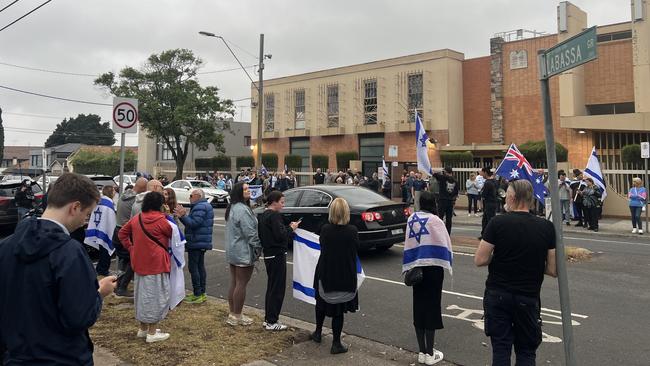 People gathered along Inkerman Rd waving Israeli flags on Monday night.