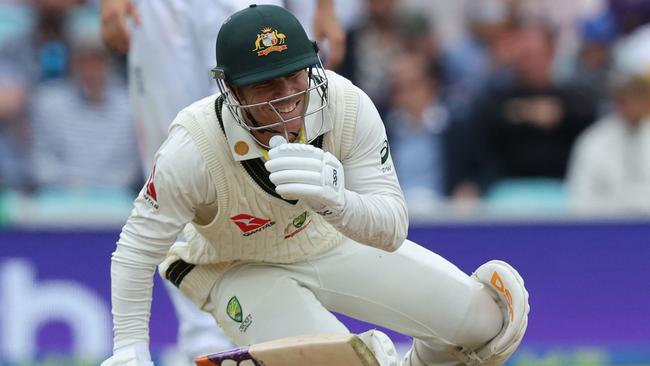 David Warner smiles after managing to avoid being hit by a loose delivery from England's James Anderson. Picture: AFP.