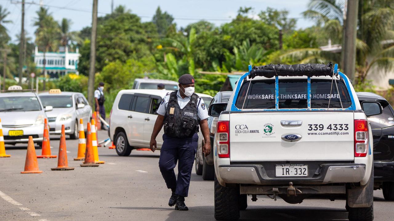 Security officers at a checkpoint in Suva. Picture: Leon Lord/AFP