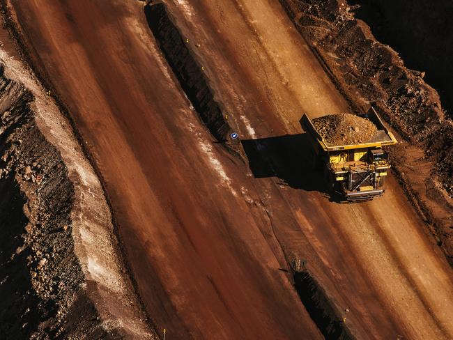 A dumper truck carries excavated iron ore from the iron ore pit at the Sishen open cast mine, operated by Kumba Iron Ore Ltd., an iron ore-producing unit of Anglo American Plc, in Sishen, South Africa, on Tuesday, May 22, 2018. Kumba Iron Ore may diversify into other minerals such as manganese and coal as Africa’s top miner of the raw material seeks opportunities for growth and to shield its business from price swings. Photographer: Waldo Swiegers/Bloomberg