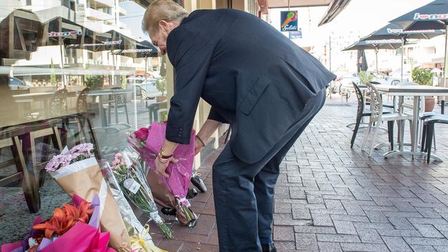 Mourners lay flowers outside the Gelobar restaurant. Picture: Jake Nowakowski