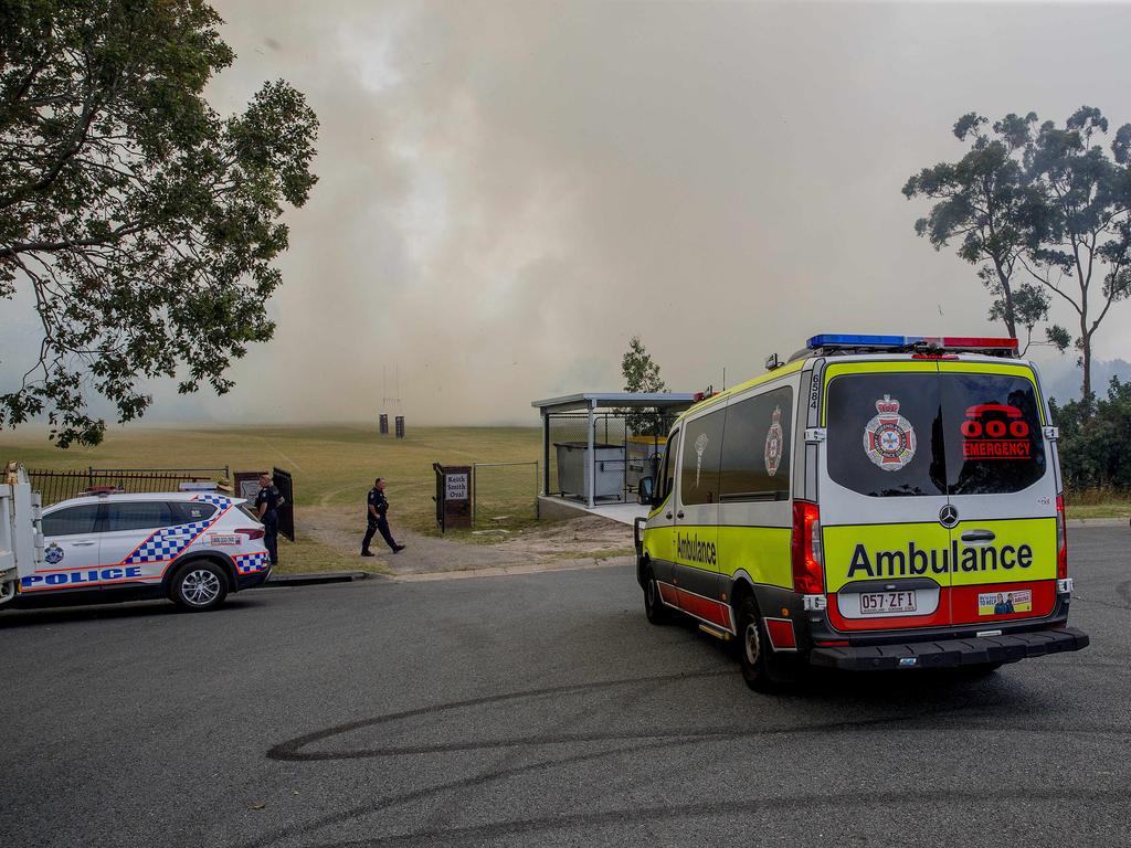 Smoke haze covers the Gold Coast Skyline from a grass fire at Carrara. Emergency services at St Michael's Collage, Merrimac. Picture: Jerad Williams