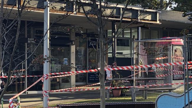 Northern Beaches Council taped off a children's playground at the Killarney Heights shopping precinct in Tremore Pl on Thursday, April 11, 2024, so a clean-up can go ahead after small fragments of asbestos sheeting was found nearby after work on a shop awning (top). Picture: Jim O’Rourke