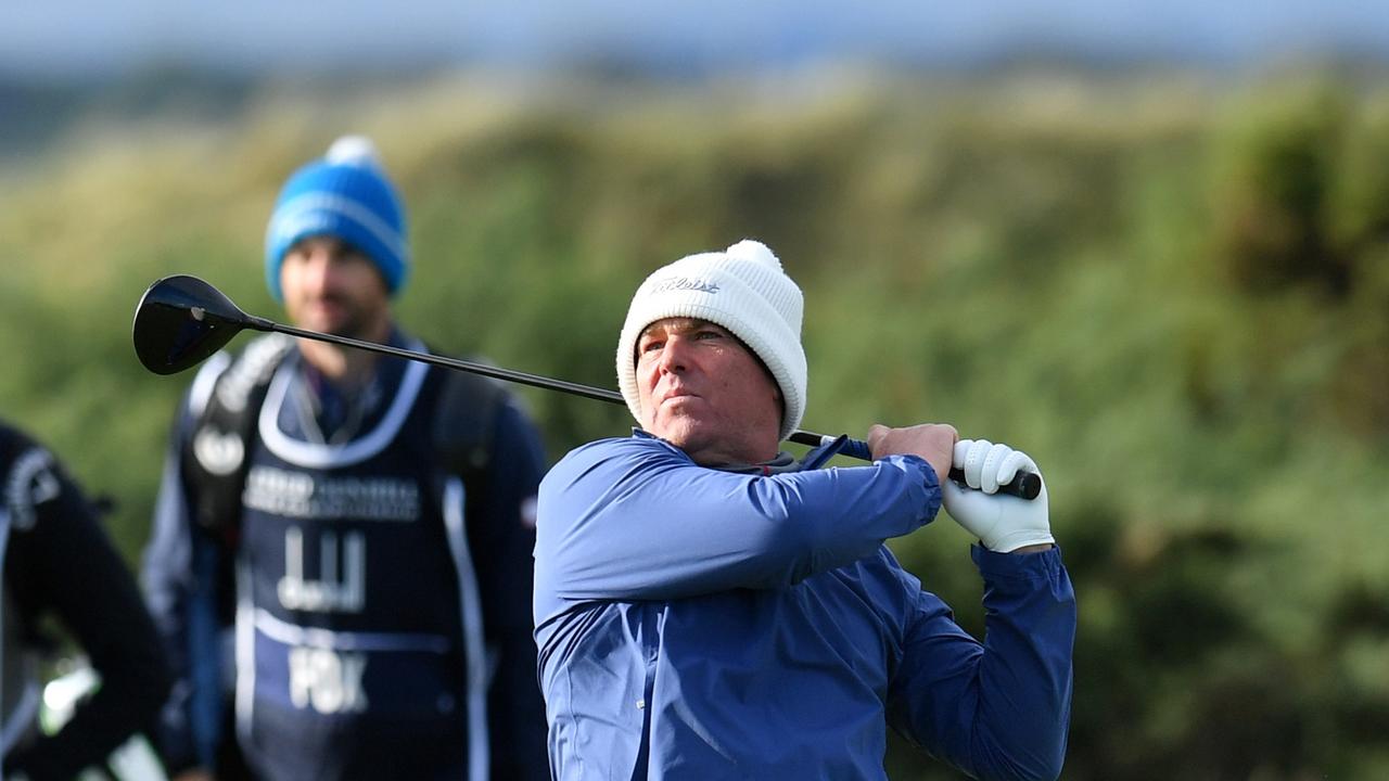 ST ANDREWS, SCOTLAND - OCTOBER 03: Former cricketer Shane Warne plays a shot on the 9th hole during Day Four of The Alfred Dunhill Links Championship at The Old Course on October 03, 2021 in St Andrews, Scotland. (Photo by Mark Runnacles/Getty Images)