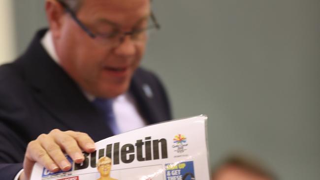 Tim Nicholls holds up the Gold Coast Bulletin’s front page story during Parliament Question Time. Pic Annette Dew