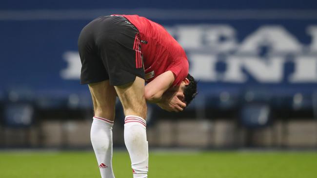 Manchester United's English defender Harry Maguire reacts at the end of the English Premier League football match between West Bromwich Albion and Manchester United at The Hawthorns stadium in West Bromwich, central England, on February 14, 2021. (Photo by Nick Potts / POOL / AFP) / RESTRICTED TO EDITORIAL USE. No use with unauthorized audio, video, data, fixture lists, club/league logos or 'live' services. Online in-match use limited to 120 images. An additional 40 images may be used in extra time. No video emulation. Social media in-match use limited to 120 images. An additional 40 images may be used in extra time. No use in betting publications, games or single club/league/player publications. /