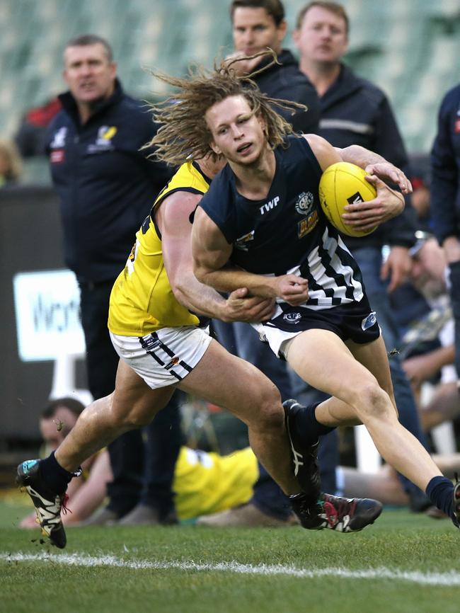 Toe the line: Campbell Floyd is tackled by Luke Tapscott. Picture: Wayne Ludbey