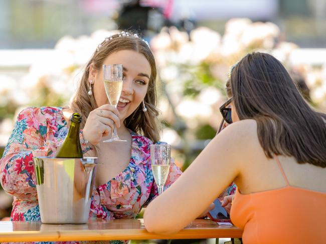 Racegoers enjoy champagne at a trackside table. Picture: Jason Edwards