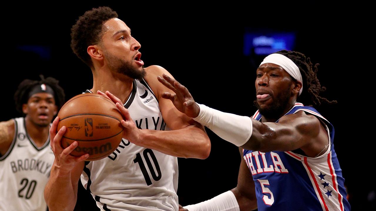 Brooklyn Nets guard D' Angelo Russell, center, shoots over Philadelphia  76ers guard Ben Simmons, during the first half game between the  Philadelphia 76ers and the Brooklyn Nets in Game 3 of their