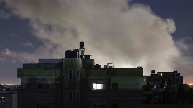 Smoke billows over buildings during Israeli bombardment south of Rafah in the southern Gaza Strip near the border with Egypt on February 17, 2024, amid ongoing battles between Israel and the Palestinian militant group Hamas. (Photo by MOHAMMED ABED / AFP)