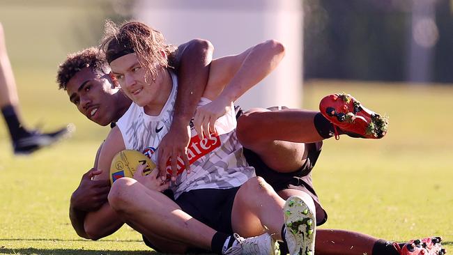 Jack Ginnivan tackled by Isaac Quaynor at Collingwood training. Picture: Michael Klein