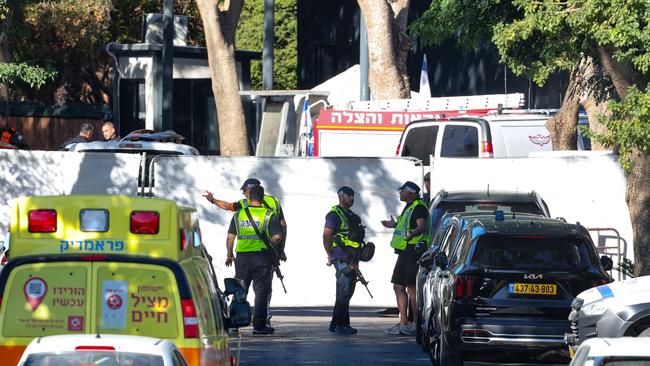 An ambulance can be seen as Israeli security forces stand guard behind a barrier acrosse a street leading to Prime Minister Benjamin Netanyahu's residence in Caesarea. Picture: AFP