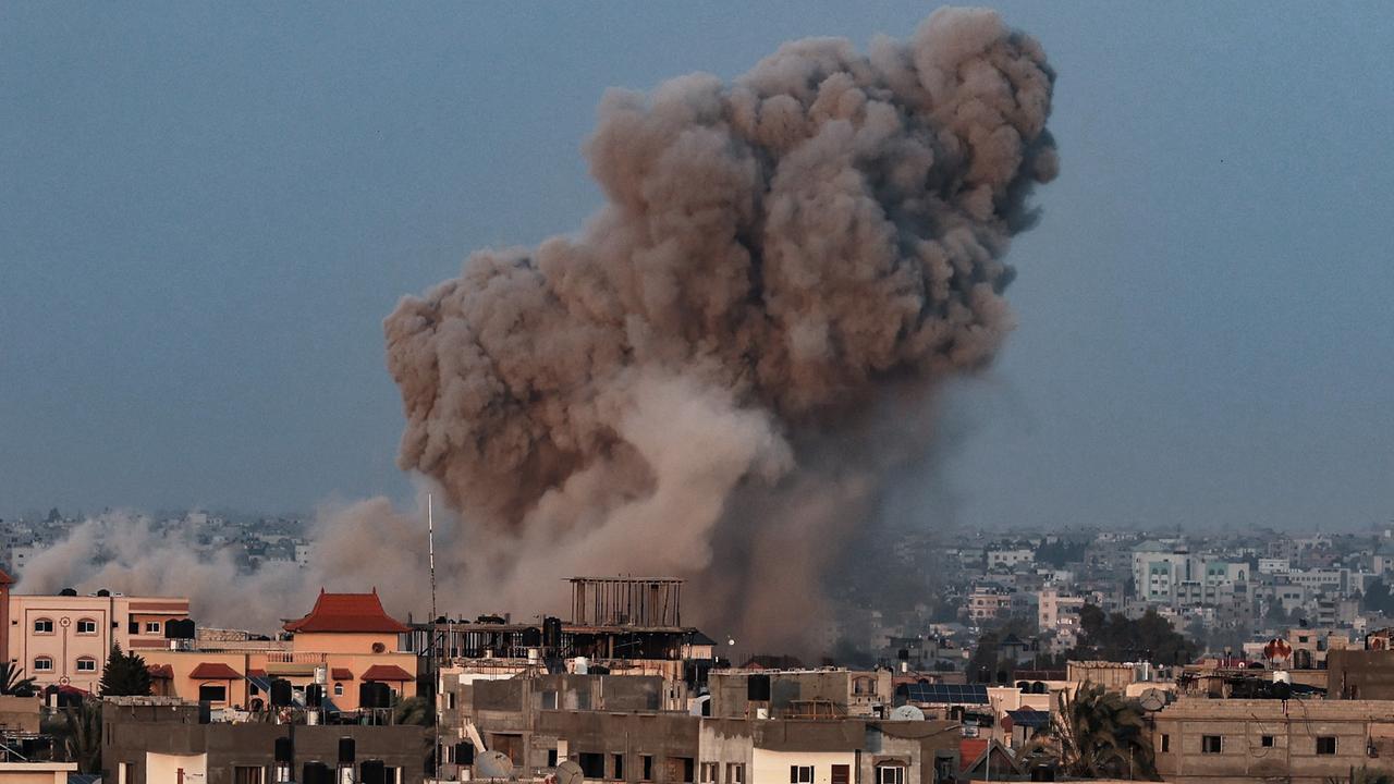 TOPSHOT - Smoke plumes rising above buildings during an Israeli strike on Rafah in the southern Gaza Strip on October 14, 2023. Picture: AFP.