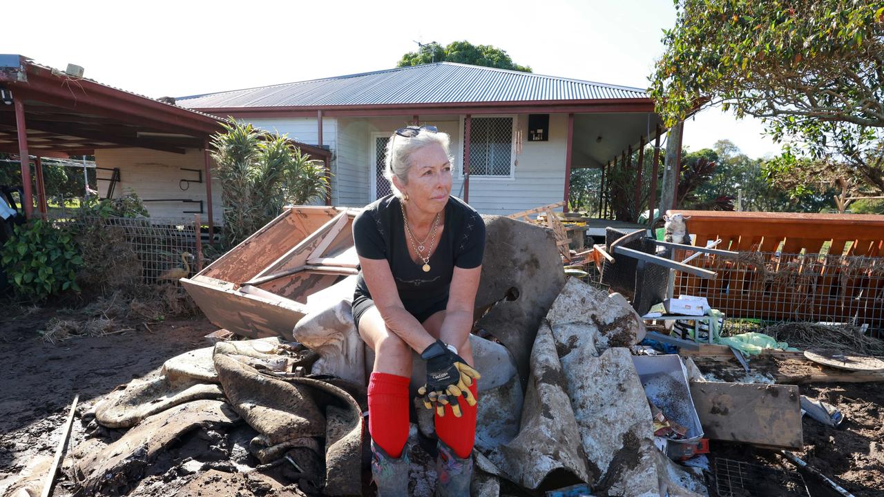 Taree beef cattle farmer Christine George looks across flood-ravaged paddock, daunted by the job in front of her to repair the damage caused by the floods. Picture: Scott Calvin