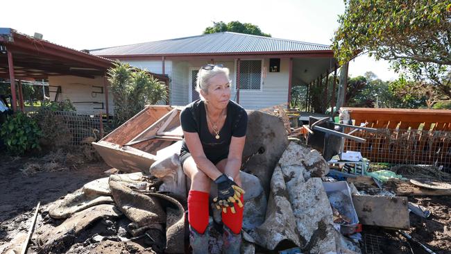 Taree beef cattle farmer Christine George looks across flood-ravaged paddock, daunted by the job in front of her to repair the damage caused by the floods. Picture: Scott Calvin