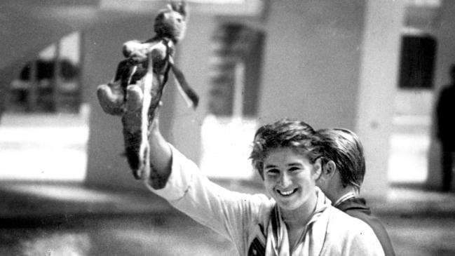 Dawn Fraser holds a toy kangaroo aloft after winning gold in the 100m freestyle final at the 1964 Tokyo Olympic Games.