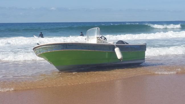 A 5.2m boat was washed up on North Narrabeen Beach after it sprang a leak while travelling between Newport and Balmain. Picture: Lewis Slarke