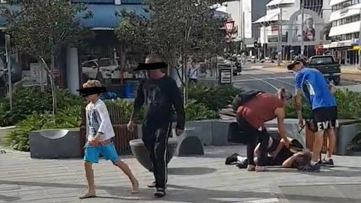 Bystanders rush to help the boy as the alleged attackers walk away.