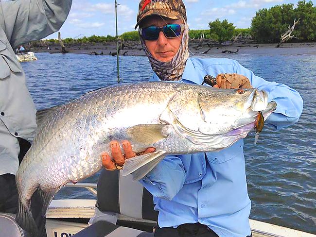 Fishing guide Andy Taylor holds a client’s metre-plus barra, caught on a suspending Atomic Shiner Double Deep