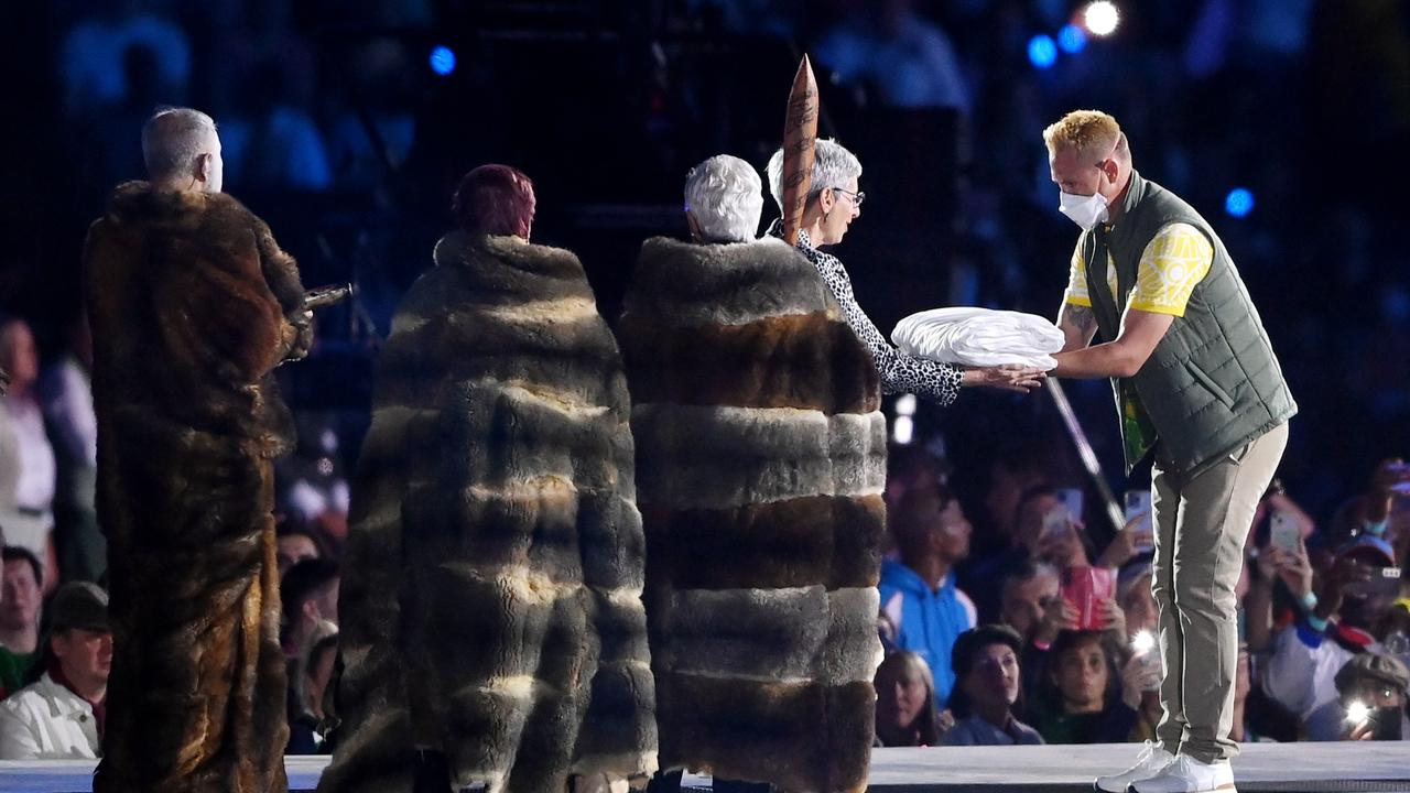 Barrie Lester of Team Australia hands the flag to Her Excellency, the Honourable Linda Dessau AC, Governor of Victoria during the Birmingham 2022 Commonwealth Games Closing Ceremony.