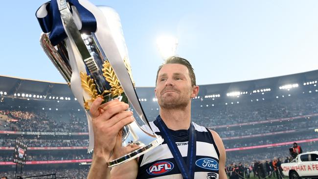 Patrick Dangerfield finally gets his hand on the premiership cup. Picture: Quinn Rooney/Getty Images