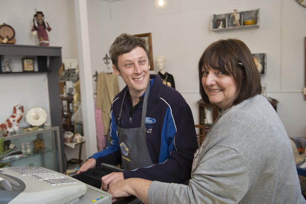 YellowBridge Queensland client Mikey Jones learns to use the cash register from Joan Goldman in the social enterprise op shop Collectables, Tuesday, June 7, 2016. Picture: Kevin Farmer