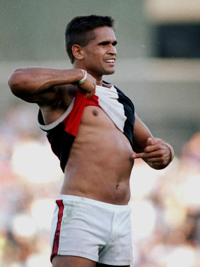 Nicky Winmar lifts his jumper and points to the colour of his skin to the Collingwood supporters during a now iconic moment at Victoria Park. Picture: John Feder