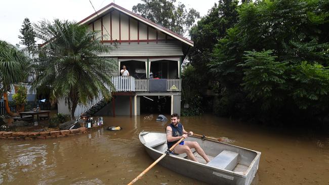 Lennon Bartlett rows a boat to his parents house next door to where he lives in central Lismore, New South Wales, Friday, March 31, 2017. The Wilsons River breached its banks early morning flooding the far-northern NSW town. (AAP Image/Dave Hunt) NO ARCHIVING