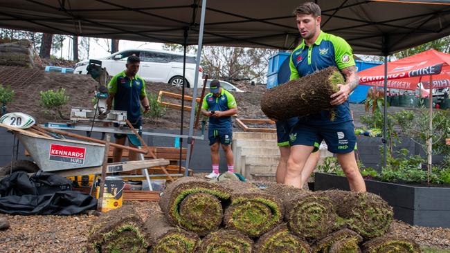 Curtis Scott helps returf Mogo Primary School which has been heavily affected by the bushfires. Picture: Canberra Raiders