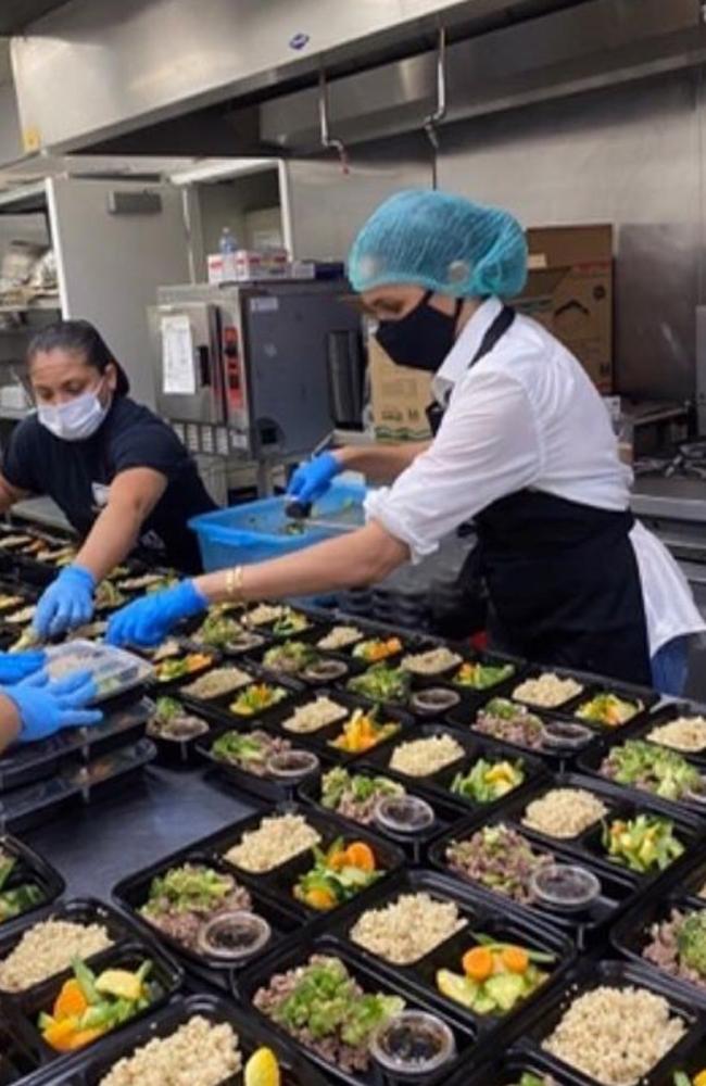 Meghan donned gloves, a mask and a hairnet as she prepared meals for the #FeedHOPE program. Picture: Twitter.