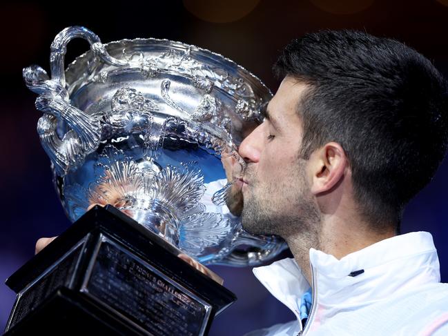 MELBOURNE, AUSTRALIA - JANUARY 29:  Novak Djokovic of Serbia kisses the Norman Brookes Challenge Cup after winning the Men's Singles Final match against Stefanos Tsitsipas of Greece during day 14 of the 2023 Australian Open at Melbourne Park on January 29, 2023 in Melbourne, Australia. (Photo by Clive Brunskill/Getty Images)