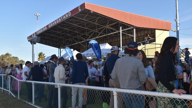 Spectators cheer on as they watch the B Grade St George vs Condamine match at the Roma Rugby Races at Bassett Park. Picture: Chloe Cufflin.