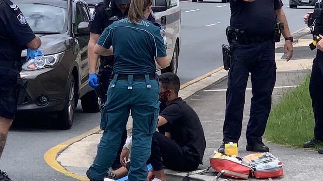 The teenager is treated by paramedics after being hit by a truck on Bermuda St. Picture: Scott Powick