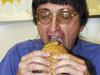 Don Gorske bites into the 18,000th Big Mac he has eaten at the Fond du lac High School in Fond du Lac, Wisconcin 06/11/2001. Gorske began his culinary obsession 17/05/1972 and is also fed by his obsessive compulsive disorder.