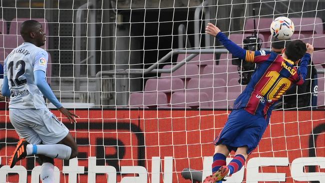 Lionel Messi heads the ball to score a goal against Valencia CF. Picture: AFP