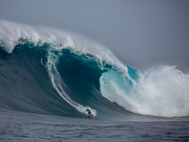 Surfer James Hollmer Cross bottom-turning on a huge wave at Eddystone Rock/Pedra Branca. Picture: Stu Gibson