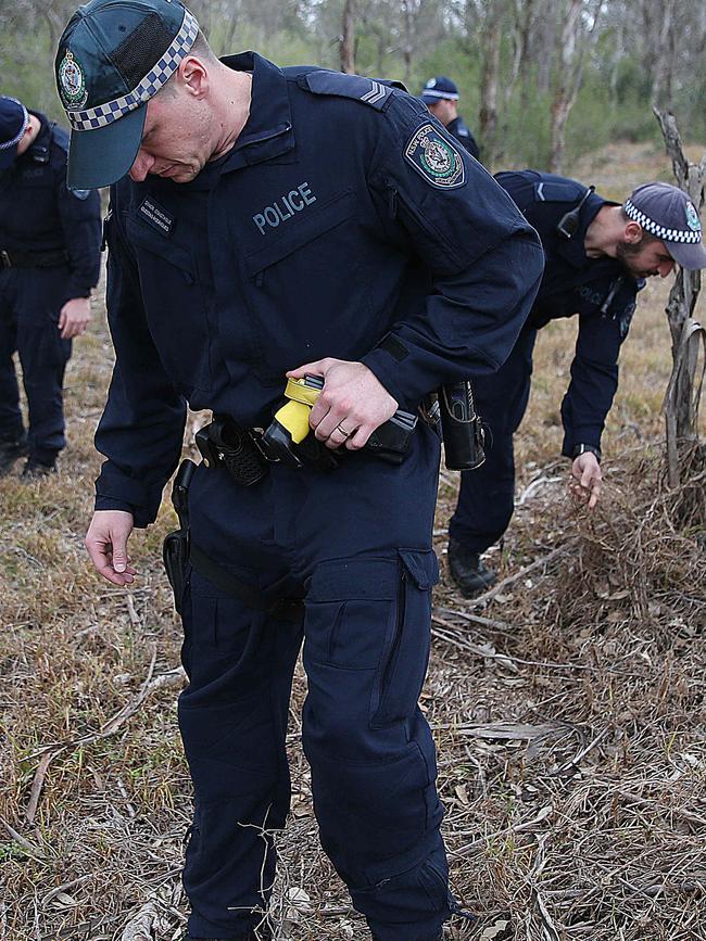 Police search bushland in West Hoxton for evidence.