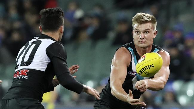 Ollie Wines fires off a handpass to Chad Wingard on Thursday night. Picture: Sarah Reed