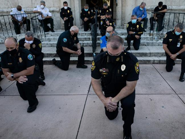 Police officers kneel during a rally in Coral Gables, Florida in response to the recent death of George Floyd. Picture: AFP