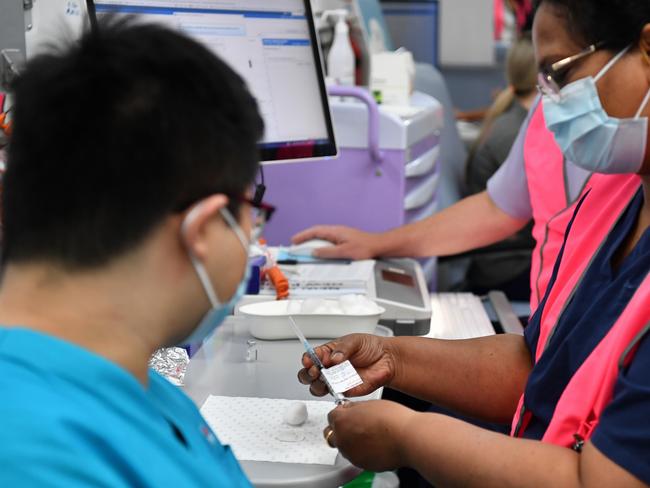 NSW Health worker Andrew Santoso, a Radiographer in the Emergency Department receives his COVID-19 vaccination at the Westmead Hospital Vaccination Hub in Sydney, Monday, March 1, 2021. Phase 1a of the nation-wide vaccination program began last week, with healthcare and border workers the first to be vaccinated. (AAP Image/Dean Lewins/POOL) NO ARCHIVING