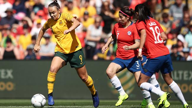 Australia’s Caitlin Foord looks to get past a couple of Chile defenders in Sydney on Saturday. Picture: Getty Images