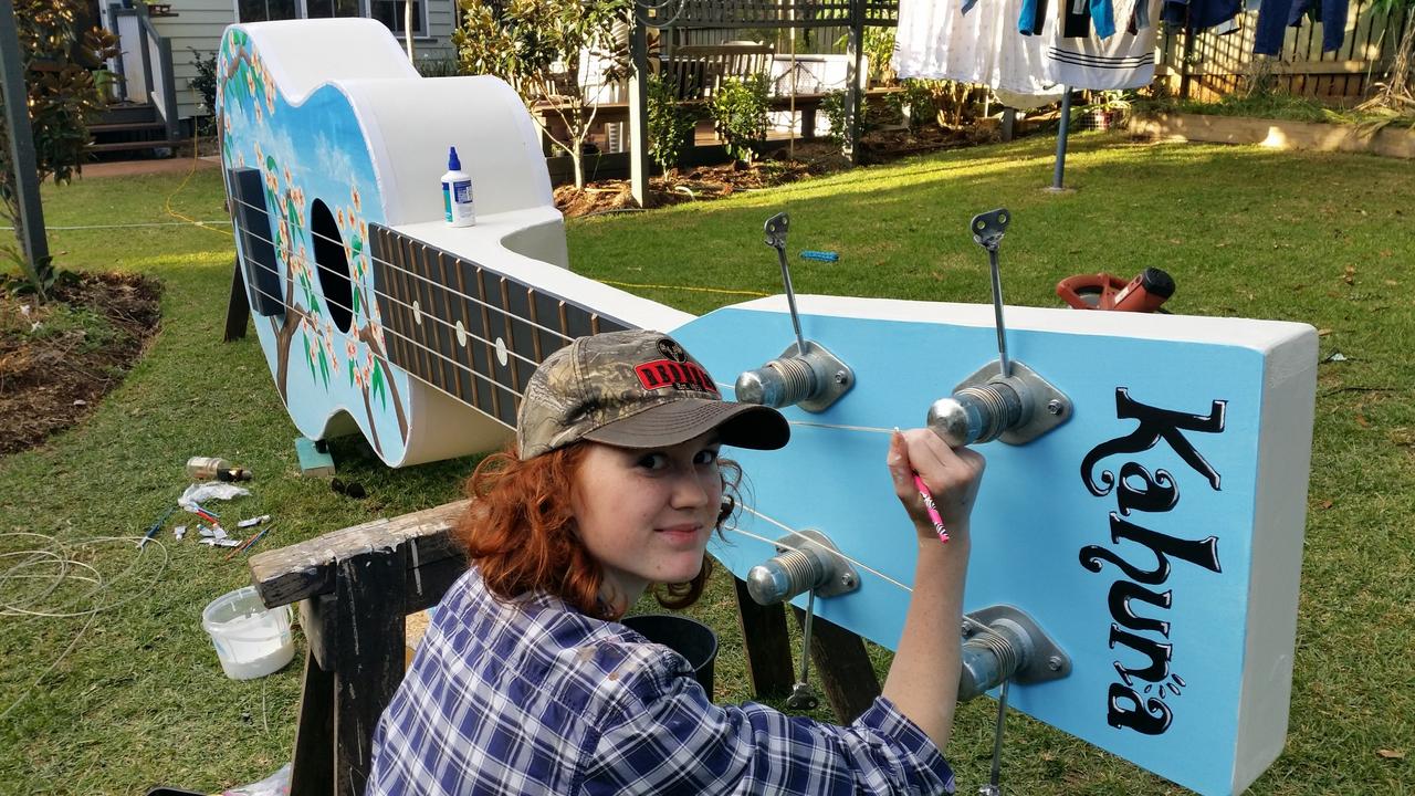 Tony Watson's daughter Abbey Watson painting the giant ukulele in the family's backyard in 2017.