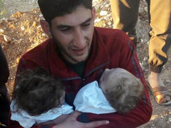 Abdul-Hamid Alyousef, 29, cries as he holds his twin babies who were killed during a suspected chemical weapons attack. Picture: AP.