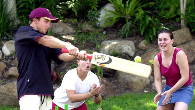 Chris Hartley celebrates scoring hs first Qld ton by playing street cricket with his sisters Justine, in red, and Caroline outside their Kenmore home. pic Lyndon Mechie