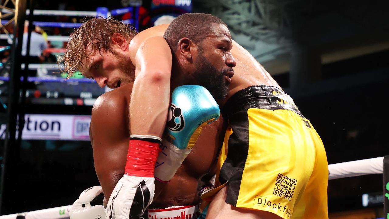 MIAMI GARDENS, FLORIDA - JUNE 06: Floyd Mayweather (green shorts) exchanges blows with Logan Paul during their contracted exhibition boxing match at Hard Rock Stadium on June 06, 2021 in Miami Gardens, Florida. (Photo by Cliff Hawkins/Getty Images)