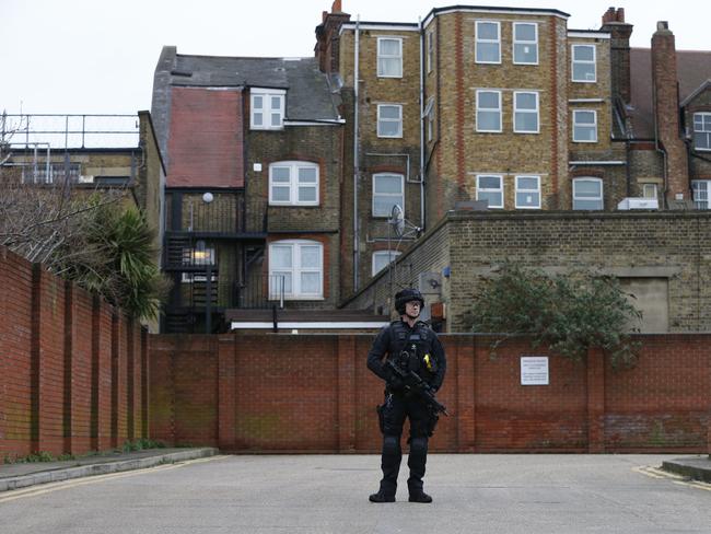 A police officer stands guard in a car park behind a Boots store near to the scene where a man was shot and killed by police. Picture: Getty Images