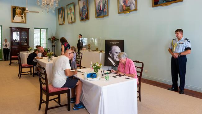 Territorians write messages of condolence to the Royal Family at Government House this morning. Picture: Che Chorley.