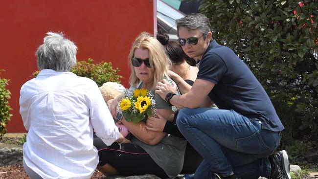 Libby Ruge's parents Julie Ruge (middle) and Jules Harrison (right) outside the Collegians Clubs the day after the crash.<span> Picture: Simon Bullard.</span>