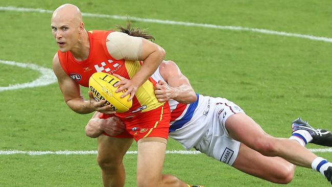 Gary Ablett of the Suns is tackled by Liam Picken of the Bulldogs during the JLTR Community Series AFL match between the Gold Coast Suns and the Western Bulldogs at Metricon Stadium on March 9, 2017 in Gold Coast, Australia. (Photo by Chris Hyde/Getty Images)